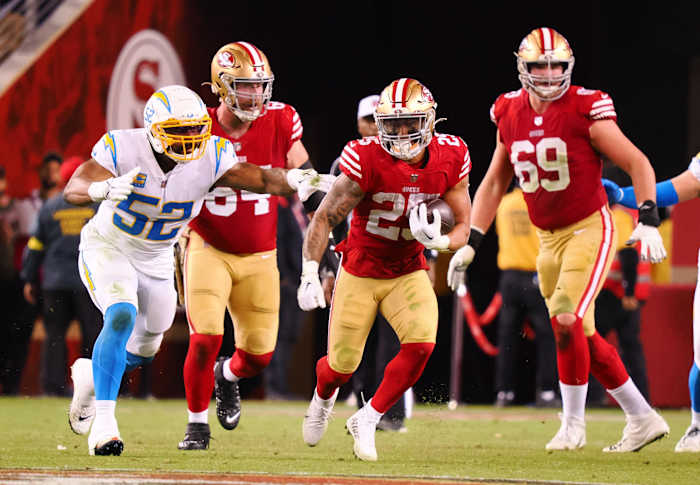 San Francisco 49ers running back Elijah Mitchell (25) carries the ball past Los Angeles Chargers linebacker Khalil Mack (52). Mandatory Credit: Kelley L Cox-USA TODAY Sports