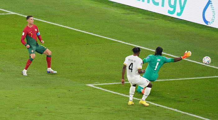 Portugal's Cristiano Ronaldo pictured (left) shooting past Ghana goalkeeper Lawrence Ati-Zigi but his goal was disallowed for an earlier foul