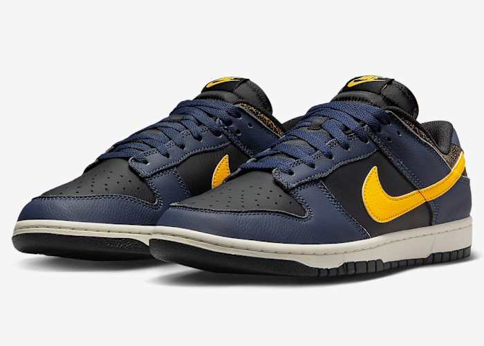 Side view of navy and black Nike Dunk Low sneakers.
