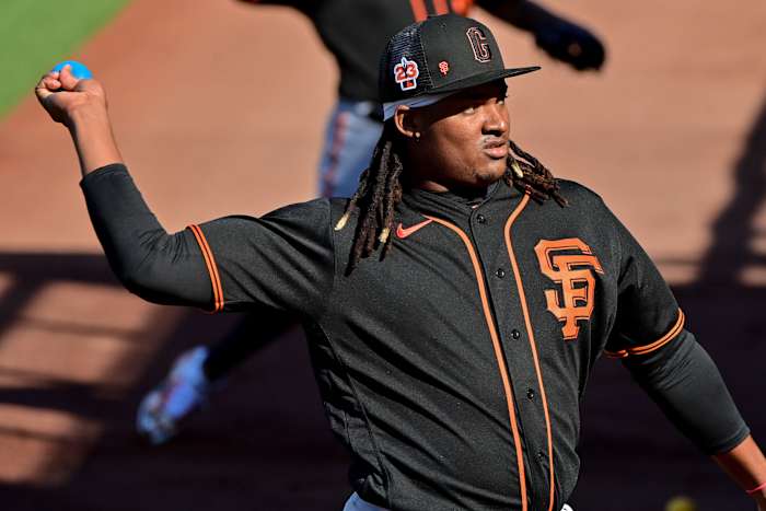 SF Giants pitcher Melvin Adon throws a weighted practice ball during a Spring Training workout at Scottsdale Stadium. (2023)