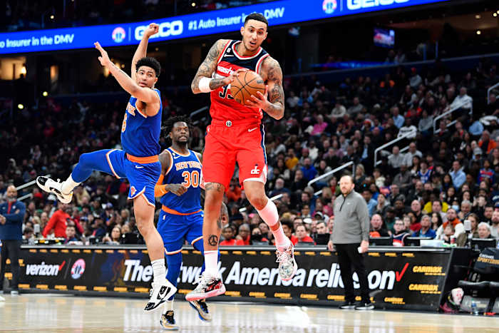 Feb 24, 2023; Washington, District of Columbia, USA; Washington Wizards forward Kyle Kuzma (33) catches the ball over New York Knicks guard Quentin Grimes (6) during the second half at Capital One Arena. Mandatory Credit: Brad Mills-USA TODAY Sports