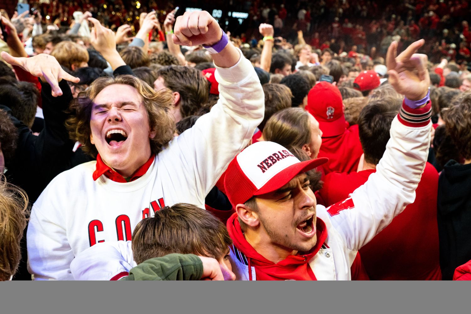 Feb 1, 2024; Lincoln, Nebraska, USA; Nebraska Cornhuskers fans storm the court after the Huskers defeated the Wisconsin Badgers at Pinnacle Bank Arena.