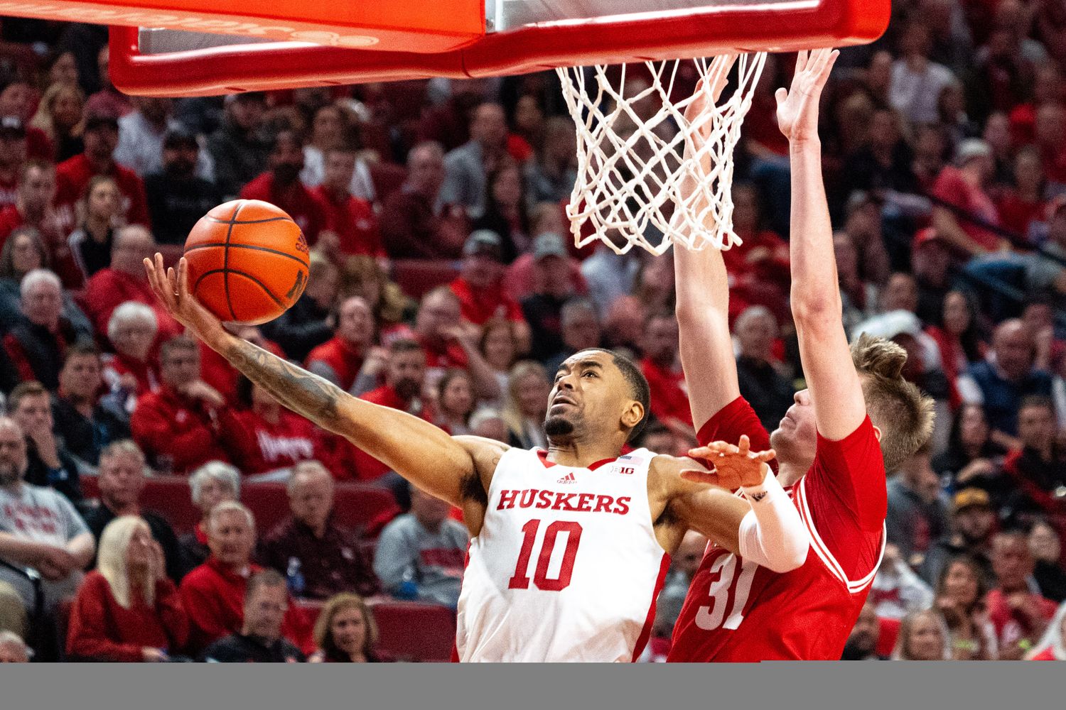 Feb 1, 2024; Lincoln, Nebraska, USA; Nebraska Cornhuskers guard Jamarques Lawrence (10) shoots the ball against Wisconsin Badgers forward Nolan Winter (31) during the first half at Pinnacle Bank Arena.
