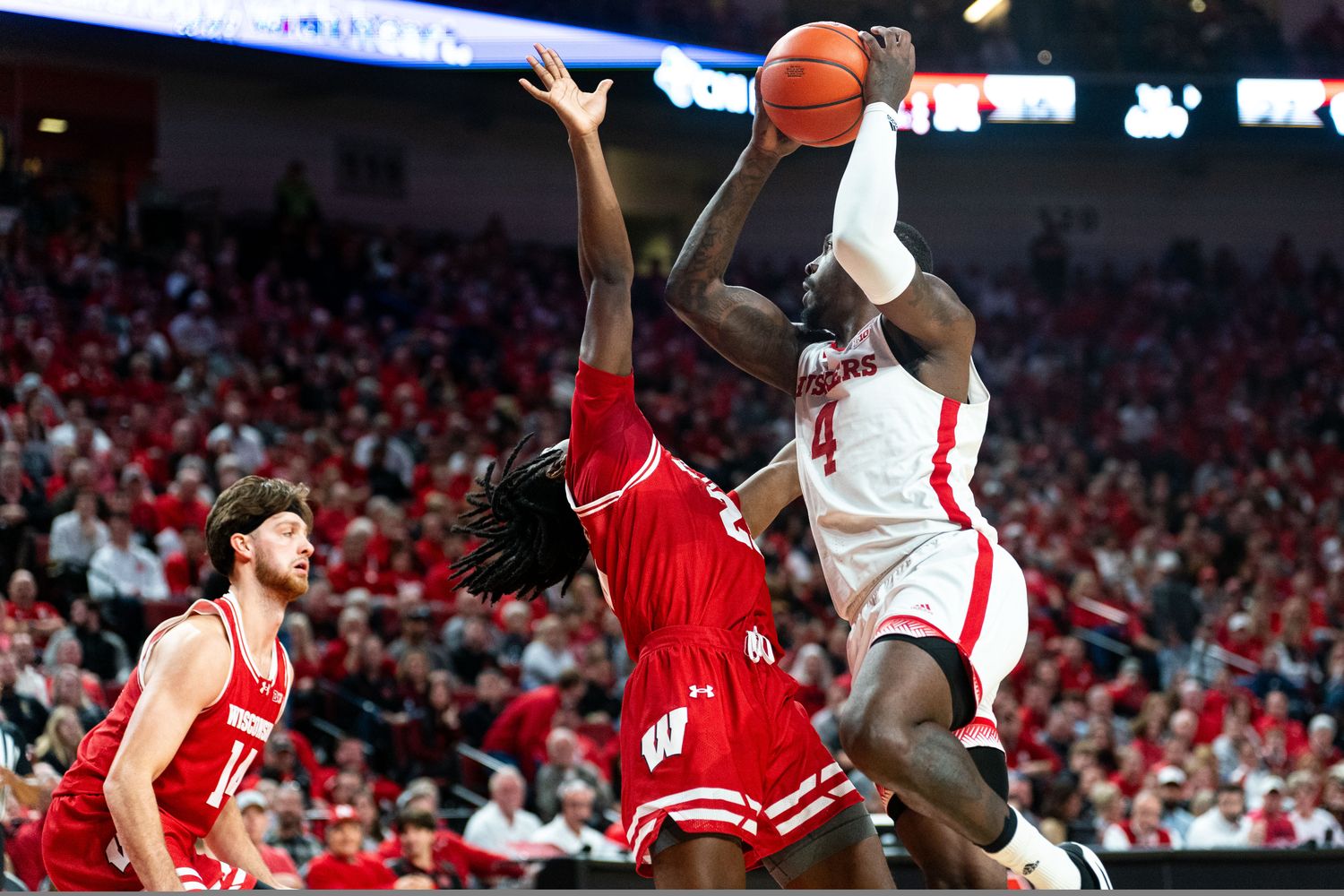 Feb 1, 2024; Lincoln, Nebraska, USA; Nebraska Cornhuskers forward Juwan Gary (4) shoots the ball against Wisconsin Badgers guard John Blackwell (25) during the first half at Pinnacle Bank Arena.