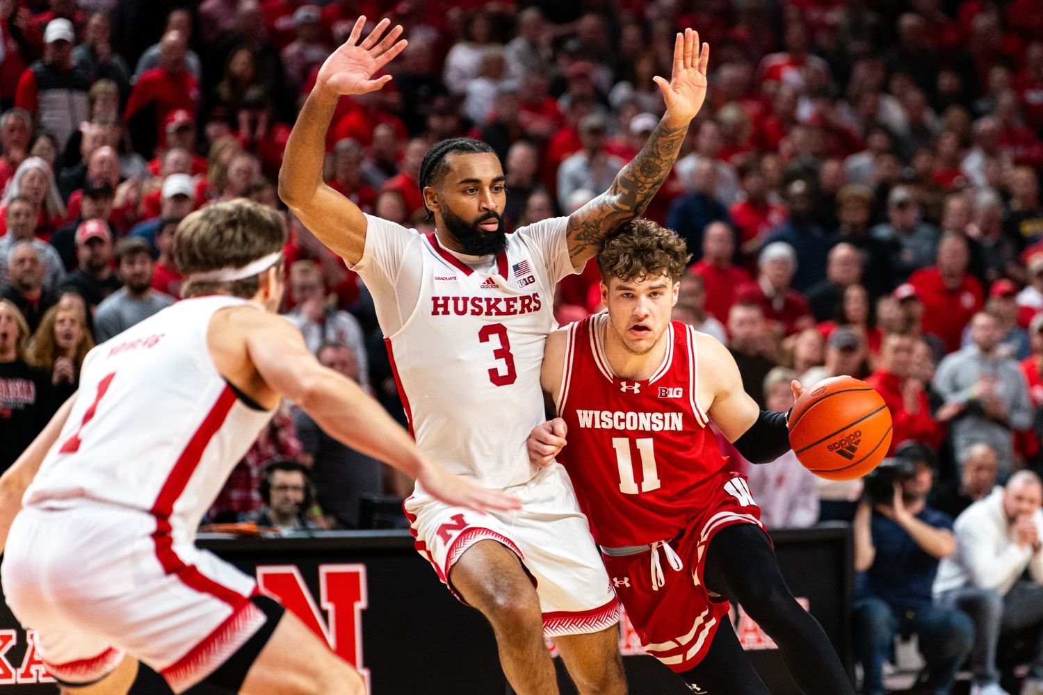 Feb 1, 2024; Lincoln, Nebraska, USA; Wisconsin Badgers guard Max Klesmit (11) drives against Nebraska Cornhuskers guard Brice Williams (3) during the second half at Pinnacle Bank Arena.