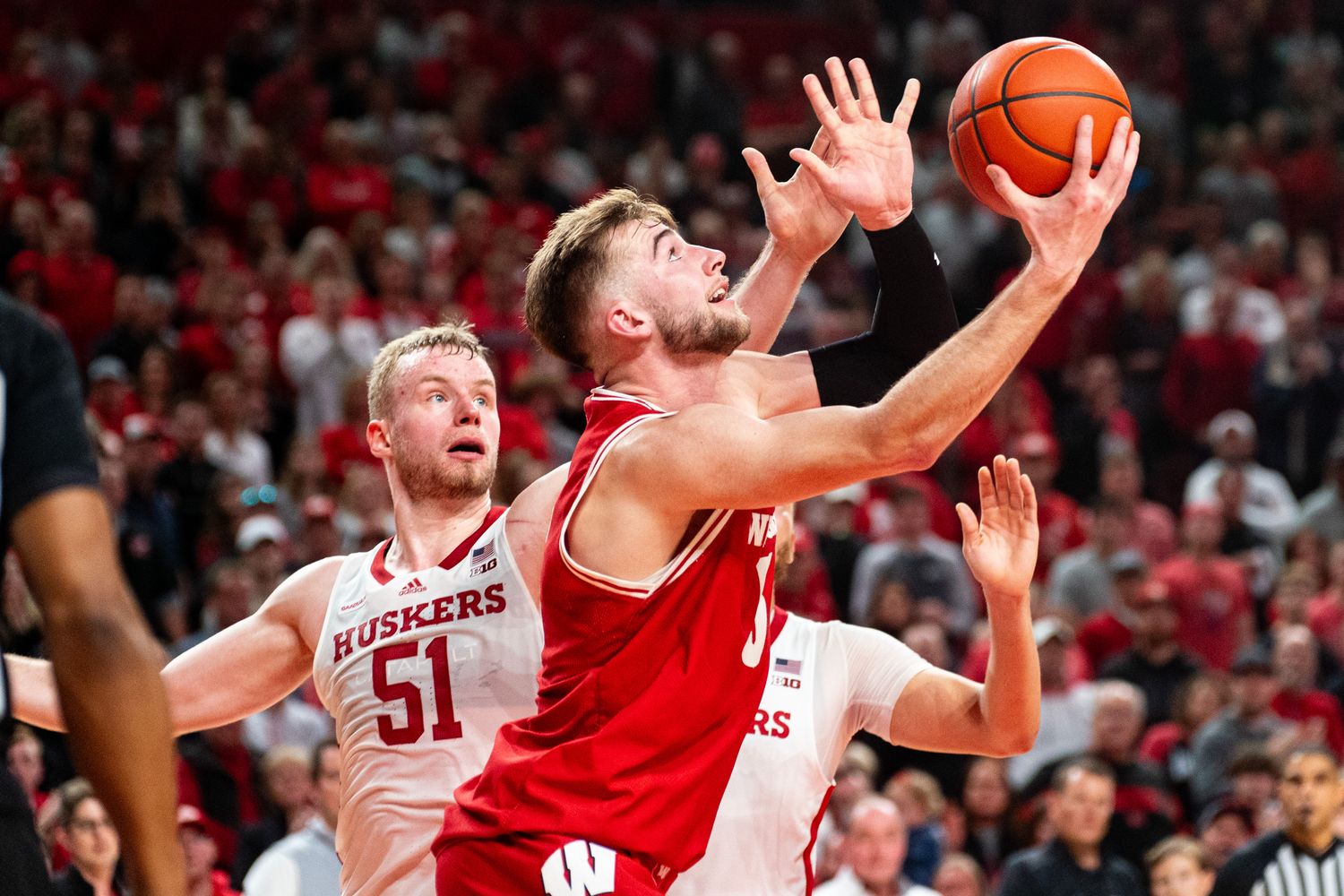 Feb 1, 2024; Lincoln, Nebraska, USA; Wisconsin Badgers forward Tyler Wahl (5) shoots the ball against Nebraska Cornhuskers forward Rienk Mast (51) and guard C.J. Wilcher (0) during overtime at Pinnacle Bank Arena.