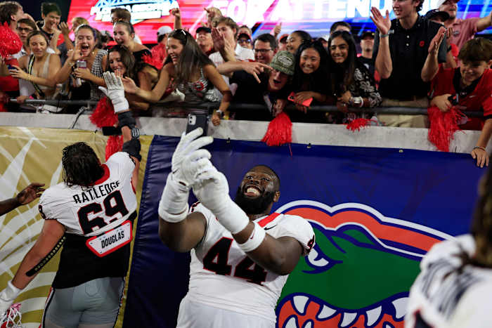 Georgia Bulldogs defensive lineman Jordan Hall (44) takes a selfie for a fan after the game of an NCAA Football game Saturday, Oct. 28, 2023 at EverBank Stadium in Jacksonville, Fla. Georgia defeated Florida 43-20.