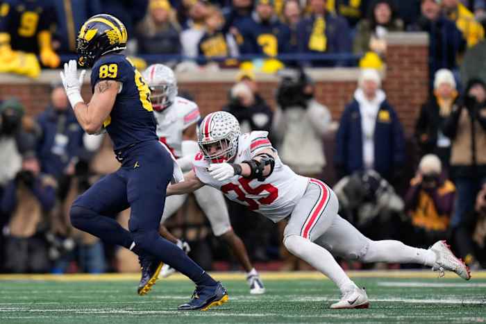 Nov 25, 2023; Ann Arbor, Michigan, USA; Ohio State Buckeyes linebacker Tommy Eichenberg (35) tries to make a tackle on Michigan Wolverines tight end AJ Barner (89) during the second half of the NCAA football game at Michigan Stadium. Ohio State lost 30-24.