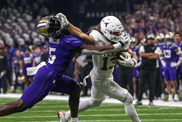 Texas Longhorns wide receiver Jordan Whittington (13) breaks a tackle by Washington linebacker Edefuan Ulofoshio (5) during the Sugar Bowl College Football Playoff semifinals game at the Caesars Superdome on Monday, Jan. 1, 2024 in New Orleans, Louisiana.