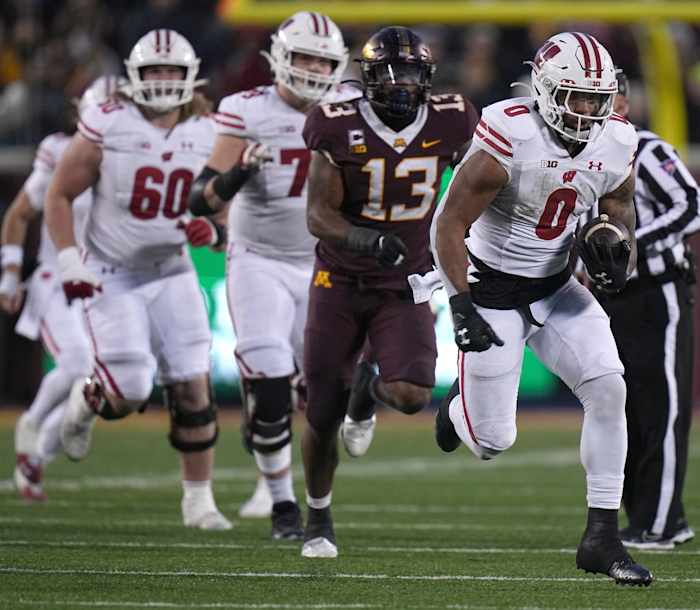 Wisconsin running back Braelon Allen (0) takes off on a 50-yard run during the third quarter of their game Saturday, November 25, 2023 at Huntington Bank Stadium in Minneapolis, Minnesota. Wisconsin beat Minnesota 28-14.
