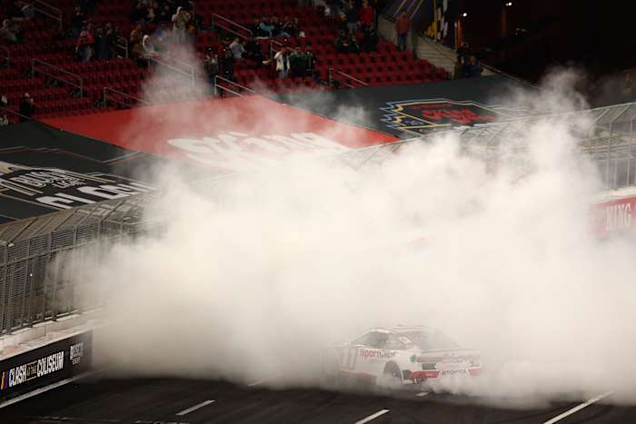 Denny Hamlin celebrates with a burnout after winning the NASCAR Cup Series Busch Light Clash at Los Angeles Memorial Coliseum on Saturday night. (Photo by Jared C. Tilton/Getty Images)