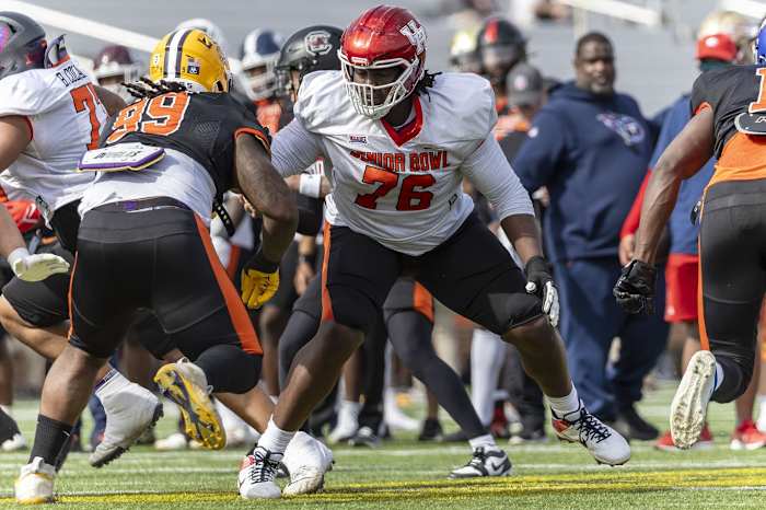 Feb 1, 2024; Mobile, AL, USA; American offensive lineman Patrick Paul of Houston (76) faces off against American defensive lineman Jordan Jefferson of LSU (99) during practice for the American team at Hancock Whitney Stadium. Mandatory Credit: Vasha Hunt-USA TODAY Sports