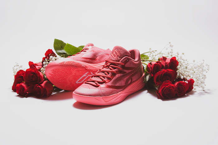 Breanna Stewart's pink and red PUMA sneakers next to roses.