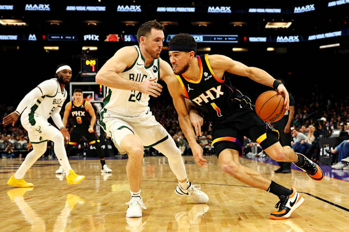 Phoenix Suns guard Devin Booker (1) drives to the basket against Milwaukee Bucks guard Pat Connaughton (24)