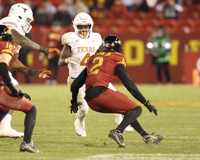 Nov 18, 2023; Ames, Iowa, USA; Iowa State Cyclones defensive back T.J. Tampa (2) looks to tackle Texas Longhorns running back CJ Baxter (4) at Jack Trice Stadium. Mandatory Credit: Reese Strickland-USA TODAY Sports