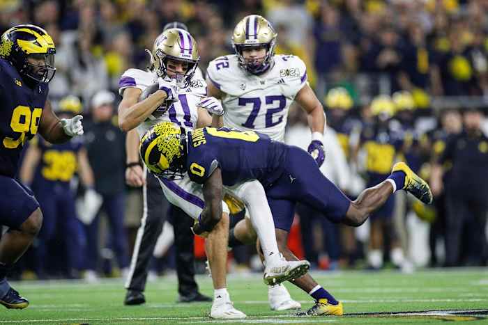 Michigan defensive back Mike Sainristil tackles Washington wide receiver Jalen McMillan during the second half of U-M's 34-13 win in the College Football Playoff national championship game in Houston on Monday, Jan. 8, 2024.