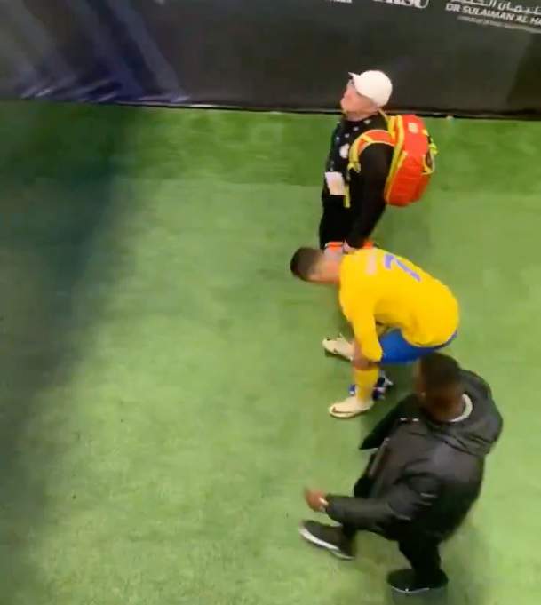 Cristiano Ronaldo pictured (center) bending down to pick up an Al-Hilal scarf before rubbing it against his crotch following his Al Nassr team's 2-0 defeat in the final game of the 2024 Riyadh Season Cup
