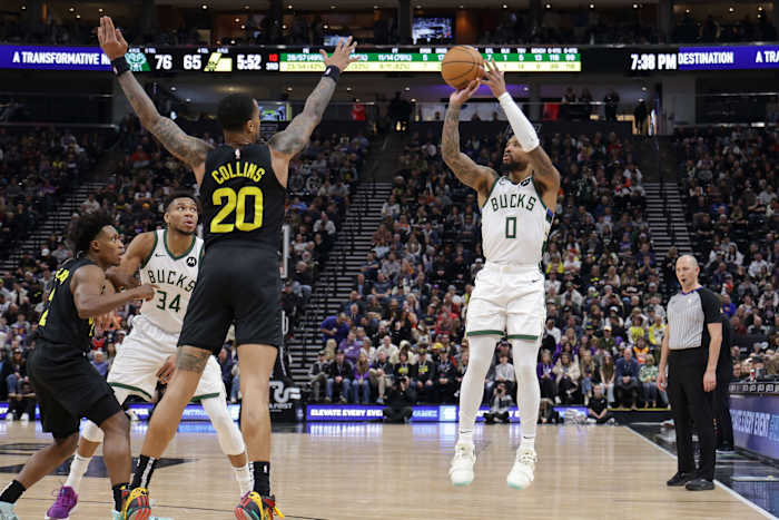 Feb 4, 2024; Salt Lake City, Utah, USA; Milwaukee Bucks guard Damian Lillard (0) shoots a three point shot during the second half against the Utah Jazz at Delta Center.