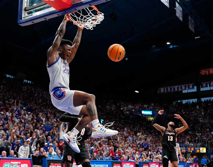 Kansas Jayhawks forward K.J. Adams Jr. (24) dunks the ball against Houston Cougars guard Mylik Wilson (8) during the second half at Allen Fieldhouse in Lawrence, Kansas, on. Feb. 3, 2024.