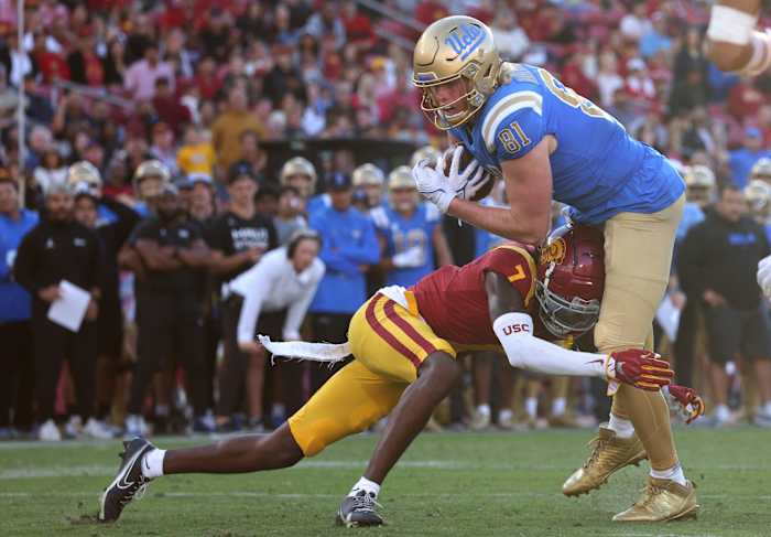 Nov 18, 2023; Los Angeles, California, USA; UCLA Bruins tight end Hudson Habermehl (81) scores a touchdown against USC Trojans safety Calen Bullock (7) during the fourth quarter at United Airlines Field at Los Angeles Memorial Coliseum. Mandatory Credit: Jason Parkhurst-USA TODAY Sports