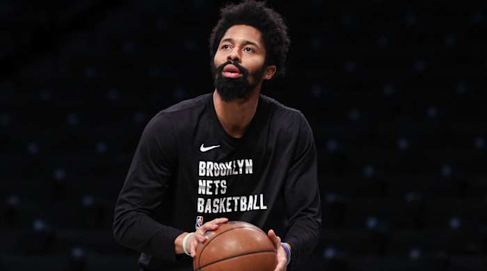 Nets point guard shoots a ball during warmups before a game.