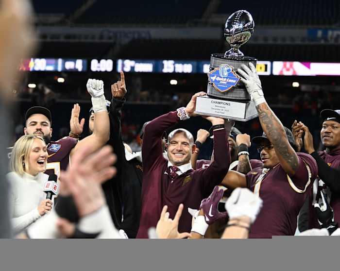 Dec 26, 2023; Detroit, MI, USA; Minnesota Golden Gophers running back Darius Taylor (1) and head coach P.J. Fleck hold up the Quick Lane Bowl trophy after defeating the Bowling Green Falcons at Ford Field.