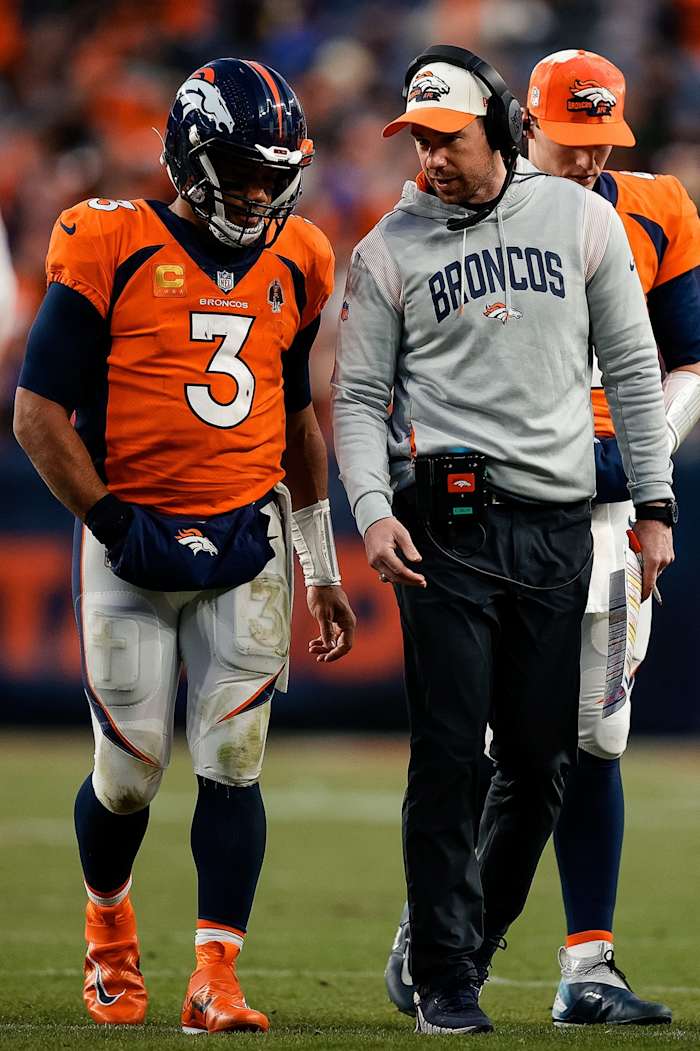 Jan 8, 2023; Denver, Colorado, USA; Denver Broncos quarterback Russell Wilson (3) talks with quarterbacks coach Klint Kubiak in the fourth quarter against the Los Angeles Chargers at Empower Field at Mile High.