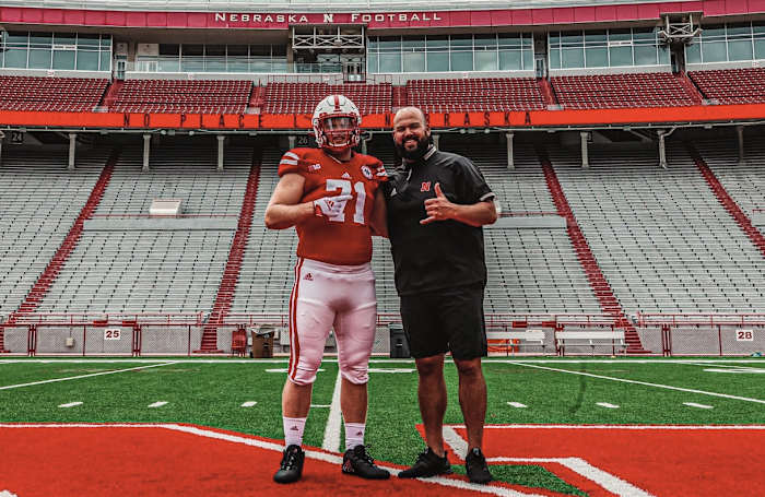 Jake Peters with Nebraska offensive line coach Donovan Raiola