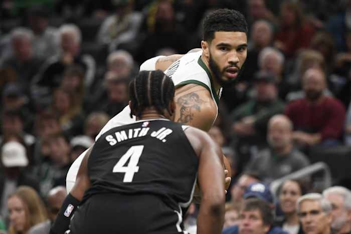 Boston Celtics forward Jayson Tatum (0) is guarded by Brooklyn Nets guard Dennis Smith Jr. (4)