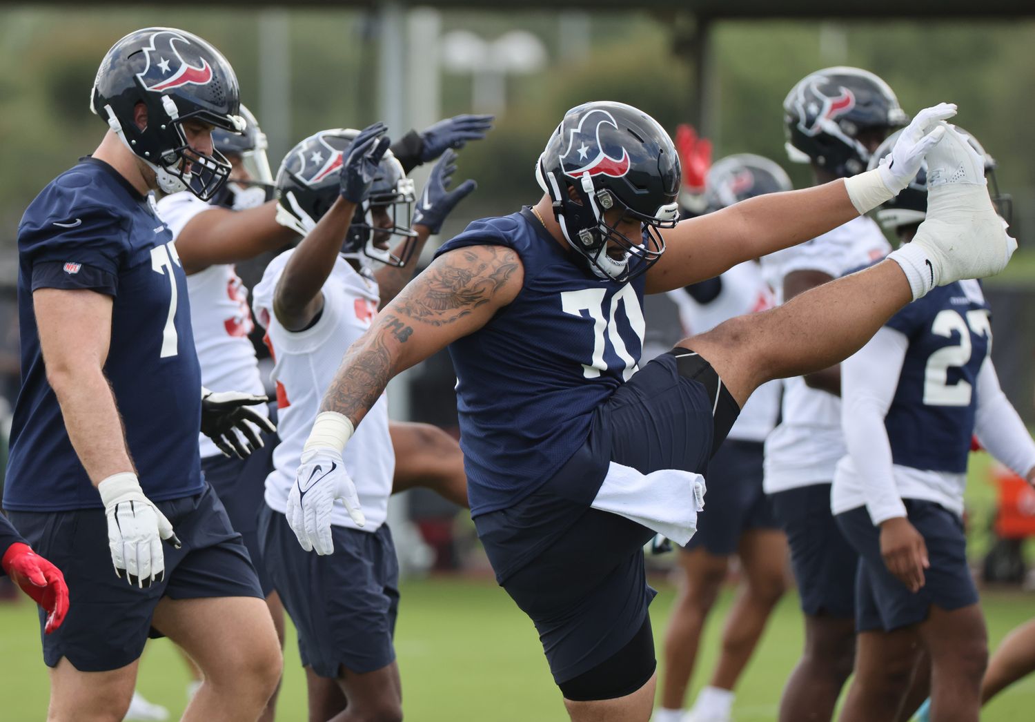Texans outside linebacker Juice Scruggs (70) stretches during rookie camp at the Methodist practice facility.