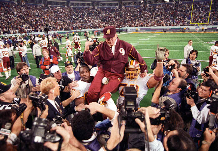 Washington Redskins head coach Joe Gibbs is carried on the field after defeating the Buffalo Bills during Super Bowl XXVI at the Metrodome. The Redskins defeated the Bills 37-24. Mandatory Credit: RVR Photos-USA TODAY Sports