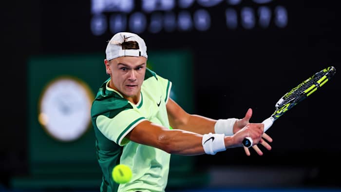 Holger Rune of Great Britain plays a shot against Arthur Cazaux at the Australian Open.