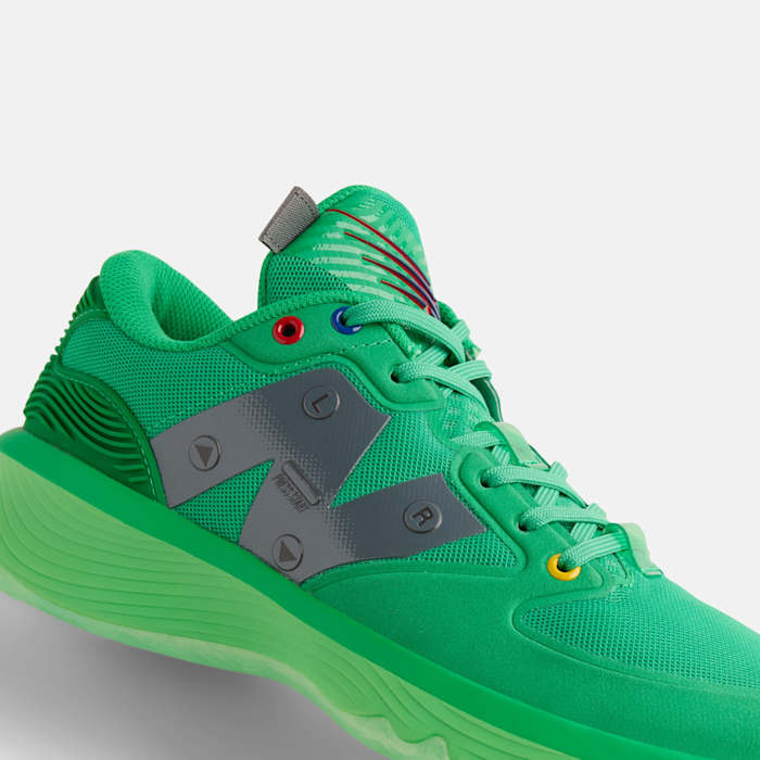 Side view of a green New Balance basketball shoe.