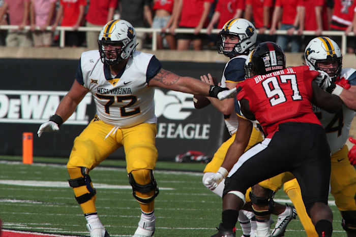 Oct 22, 2022; Lubbock, Texas, USA; West Virginia Mountaineers offensive tackle Doug Nester (72) prepares to block for quarterback JT Daniels (18) as Texas Tech Red Raiders defensive tackle Tony Bradford Jr. (97) rushes in the second half at Jones AT&T Stadium and Cody Campbell Field. Mandatory Credit: Michael C. Johnson-USA TODAY Sports