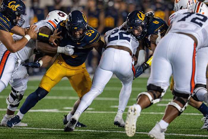 Sep 9, 2023; Berkeley, California, USA; Auburn Tigers running back Damari Alston (22) rushes with the football against California Golden Bears linebacker Kaleb Elarms-Orr (53) and California Golden Bears linebacker Jackson Sirmon (8) during the fourth quarter at California Memorial Stadium. Mandatory Credit: Neville E. Guard-USA TODAY Sports