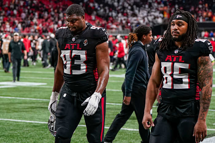 Dec 10, 2023; Atlanta, Georgia, USA; Atlanta Falcons defensive tackle Calais Campbell (93) and tight end MyCole Pruitt (85) leave the field after being defeated by the Tampa Bay Buccaneers at Mercedes-Benz Stadium.