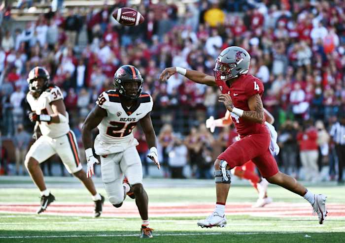 Oregon State Beavers defensive back Kitan Oladapo (28) pressures Washington State Cougars quarterback Jayden de Laura (4).