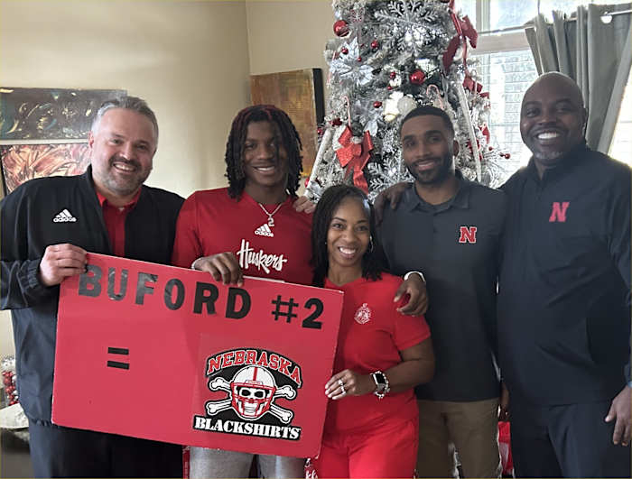 Mario Buford with his parents and coaches Matt Rhule and Evan Cooper.
