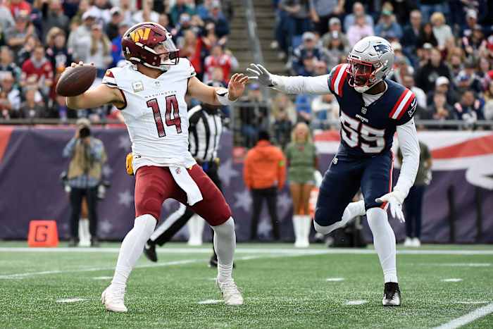 Nov 5, 2023; Foxborough, Massachusetts, USA; Washington Commanders quarterback Sam Howell (14) gets set to throw a pass while New England Patriots linebacker Josh Uche (55) defends during the first half at Gillette Stadium.