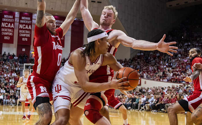Feb 21, 2024; Bloomington, Indiana, USA; Indiana Hoosiers forward Malik Reneau looks to pass while Nebraska Cornhuskers guard C.J. Wilcher (0) and forward Rienk Mast defend in the first half at Simon Skjodt Assembly Hall.