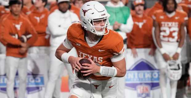Texas Longhorns quarterback Arch Manning attempts a pass during a college football game in the SEC.