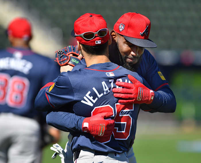 Atlanta Braves teammates Andrew Velazquez (#65) and Marcel Ozuna (#20) greet each other with a hug at the start of the team's first full squad workout Tuesday, Feb. 20, 2024 at CoolToday Park in North Port, Florida.
