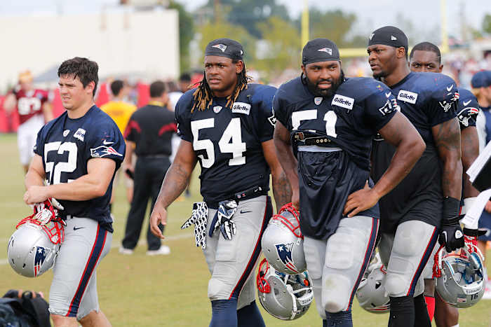 Aug 4, 2014; Richmond, VA, USA; New England Patriots linebacker James Morris (52), Patriots outside linebacker Dont'a Hightower (54), and Patriots outside linebacker Jerod Mayo (51) leave the field after joint practice with the New England Patriots on day ten of training camp at the Bon Secours Washington Redskins Training Center.
