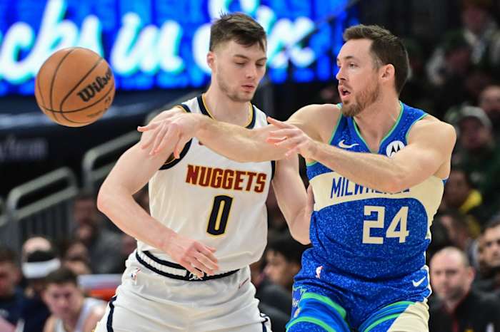 Milwaukee Bucks guard Pat Connaughton (24) passes against Denver Nuggets forward Christian Braun (0) 