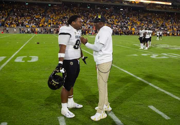 Colorado Buffaloes head coach Deion Sanders talks to defensive lineman Bishop Thomas (95) against the Arizona State Sun Devils at Mountain America Stadium