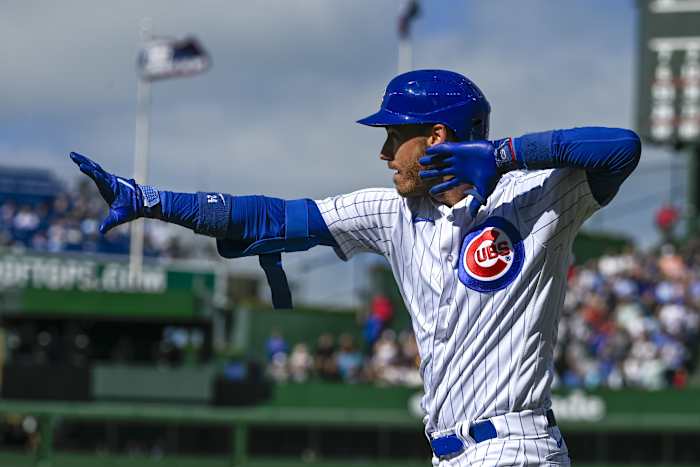 Aug 30, 2023; Chicago, Illinois, USA; Chicago Cubs center fielder Cody Bellinger (24) signals after he hits an RBI single against the Milwaukee Brewers during the eighth inning at Wrigley Field.