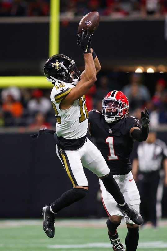 New Orleans Saints receiver Chris Olave (12) catches a pass over Atlanta Falcons cornerback Jeff Okudah (1). Mandatory Credit: Brett Davis-USA TODAY Sports