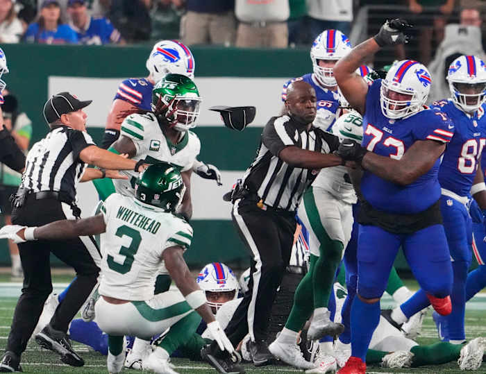 Sep 11, 2023; East Rutherford, New Jersey, USA; New York Jets safety Jordan Whitehead (3) gets pushed down by Buffalo Bills offensive tackle Dion Dawkins (73) in a scuffle following a Jets recovery of a Bills fumble in the second half at MetLife Stadium.