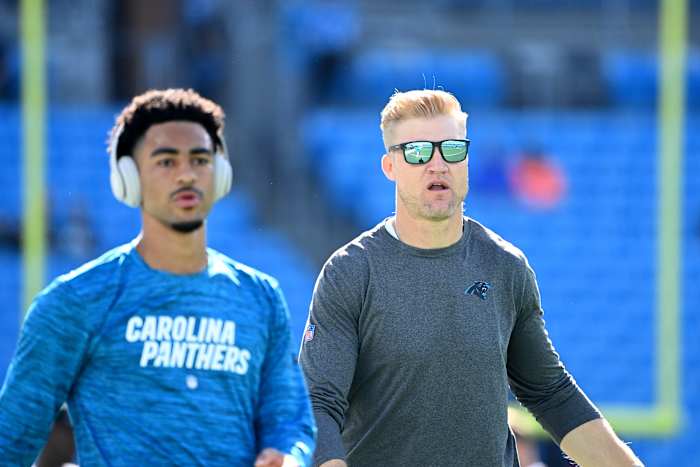 Oct 29, 2023; Charlotte, North Carolina, USA; Carolina Panthers quarterbacks coach Josh McCown behind quarterback Bryce Young (9) during wam ups at Bank of America Stadium.