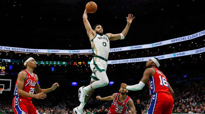Boston Celtics forward Jayson Tatum (0) goes in for a dunk as Philadelphia 76ers forward Darius Bazley (25) and guard Ricky Council IV (16) look on during the second half at TD Garden in Boston, Massachusetts, on Feb. 27, 2024.